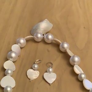 Genuine shell pendant 2 inches long, and 1 and 3/4  inches .wide.